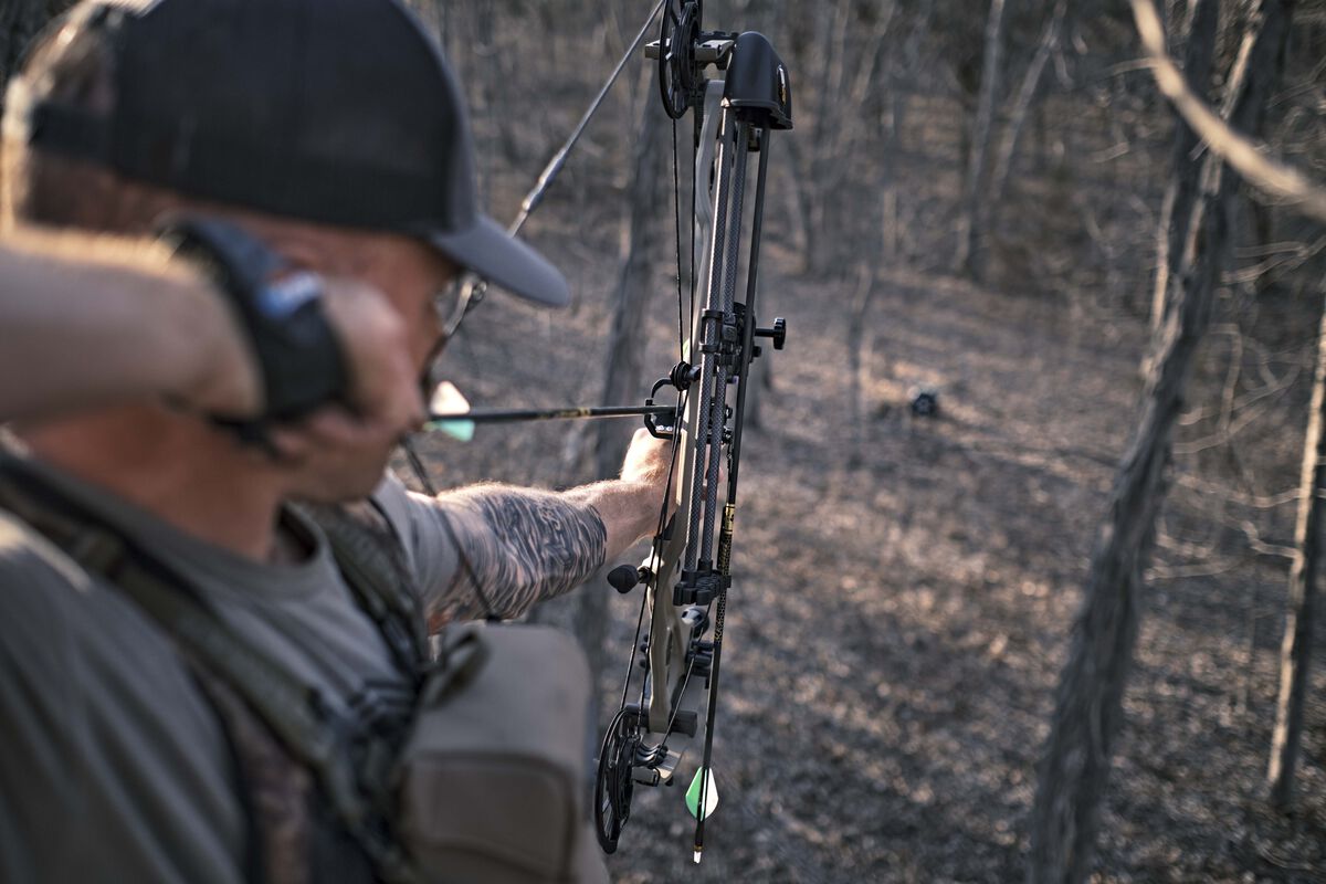 Man shooting bow and arrow