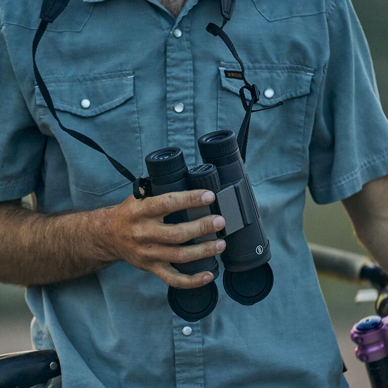 man holding binoculars